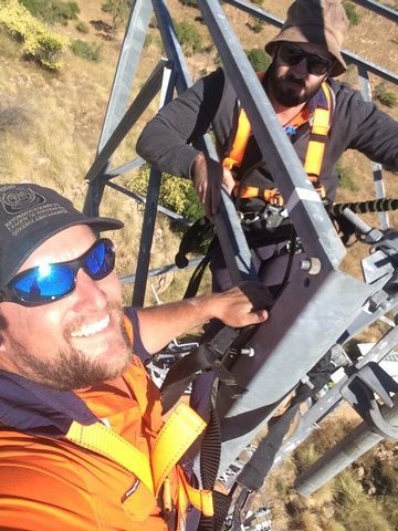 Two Men Are Standing on Top of a Metal Structure — Sape Industries in Garbutt, QLD