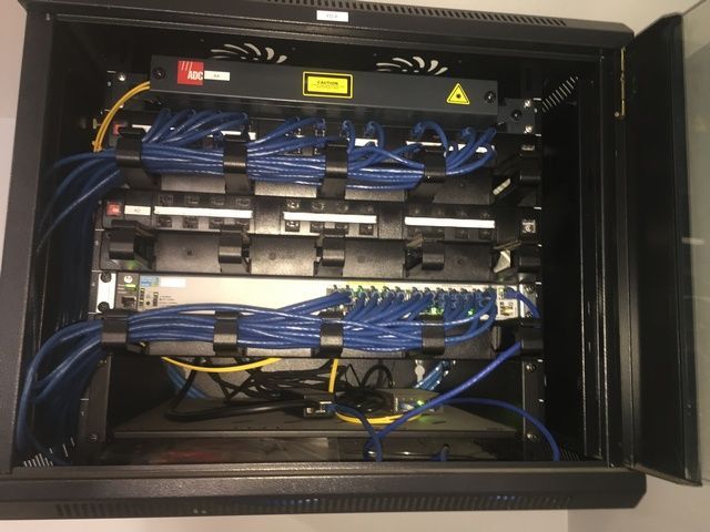 Server Rack With a Lot of Wires Coming Out of It — Sape Industries in Garbutt, QLD