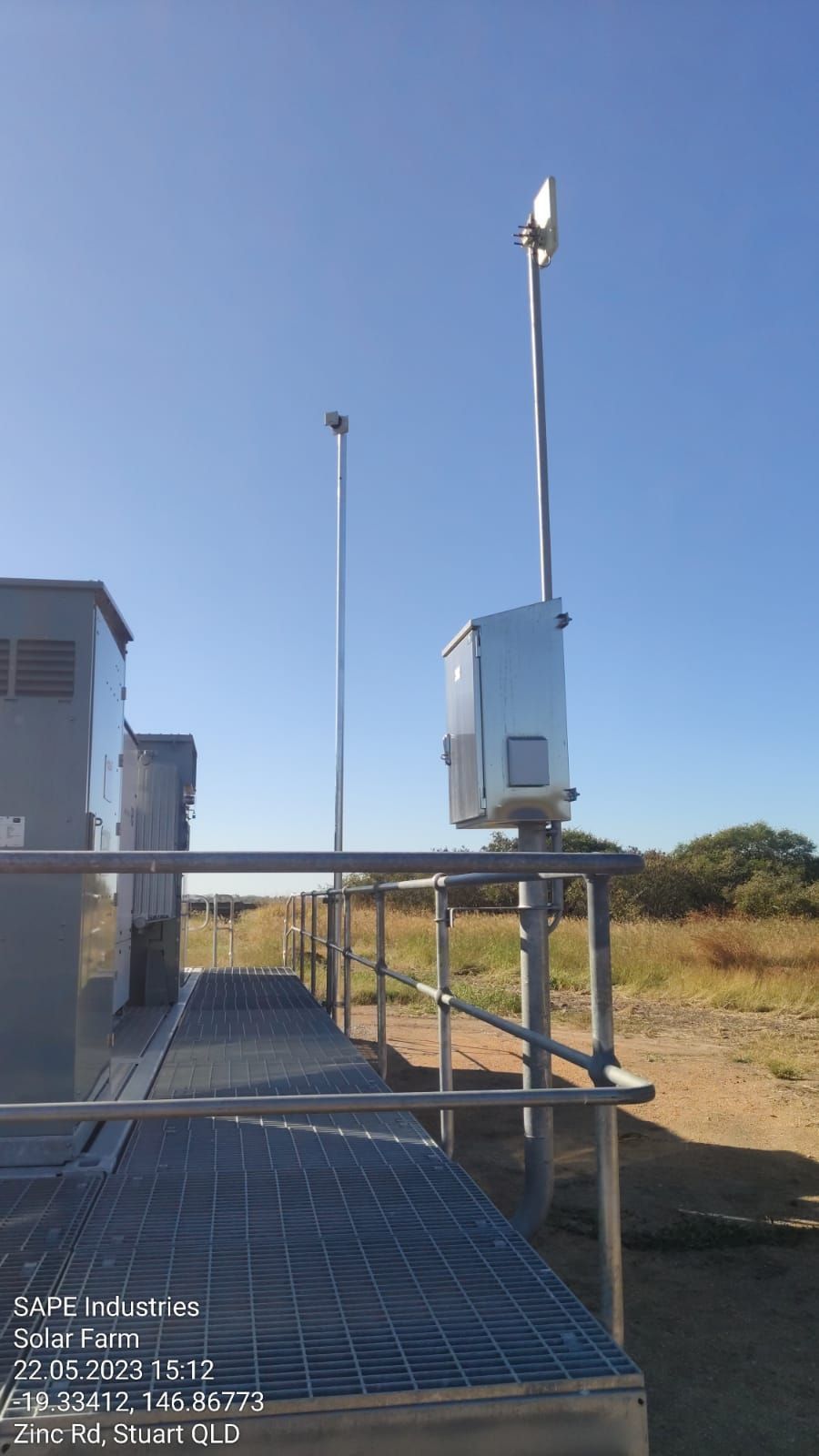A metal platform with a fence and a box on top of it.