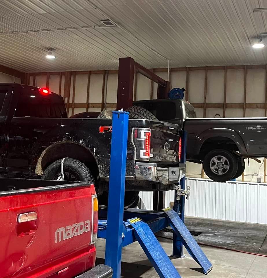 Red Pickup Truck On Lift Inside Auto Repair Shop | Fox Total Car Care LLC