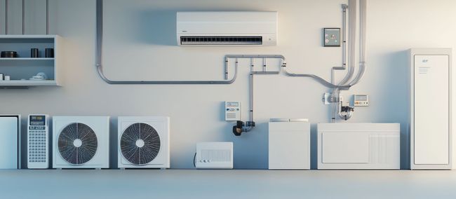 Wall-mounted HVAC setup with ducts, fans, compressor units, and an indoor air conditioner in a light blue room