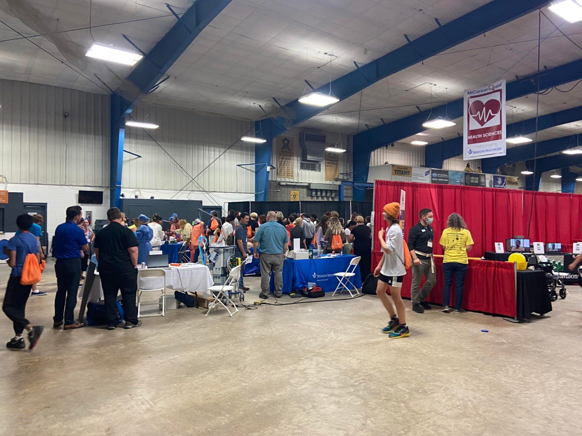 A group of people are standing in a large room.