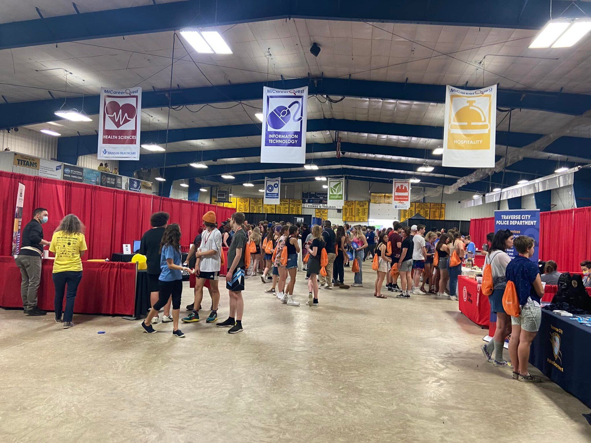 A large group of people are standing in a large room.