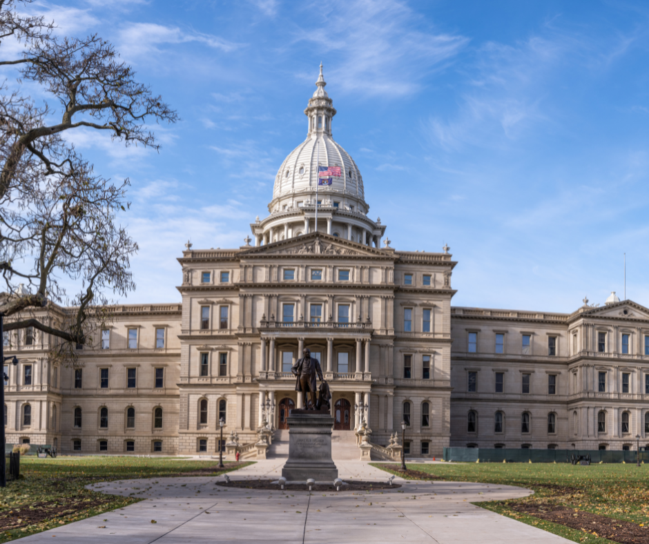 A large building with a dome and a statue in front of it.