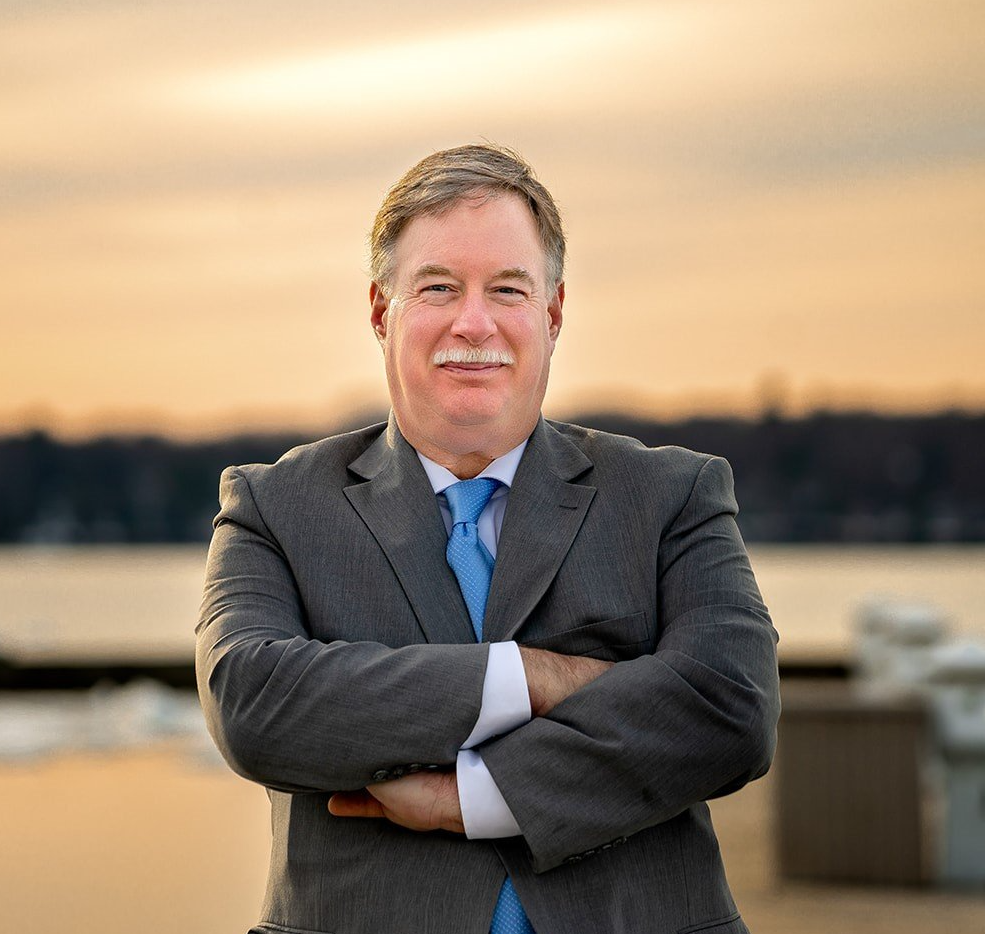 John Roth standing with his arms crossed.