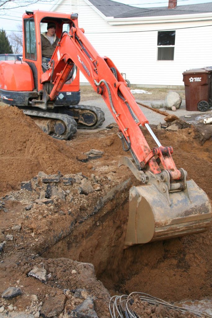 Excavator gathering dirt — Allegan, MI — Tim Rogers Plumbing LLC