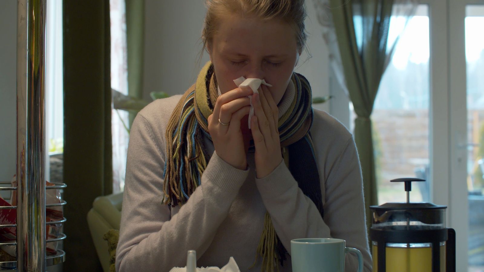 A woman trying to clear her blocked nose