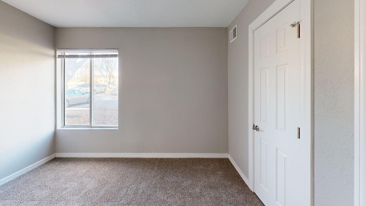 Bedroom with window and carpeting