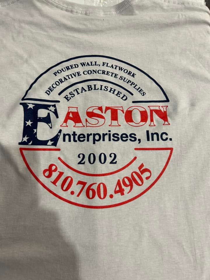 Logo for Easton Enterprises, Inc. on a light shirt, featuring red, white, and blue text, stars, and a phone number.