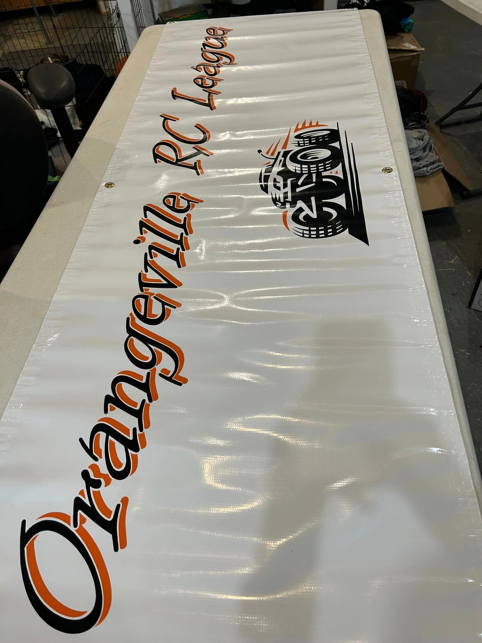 A white banner on a table reads