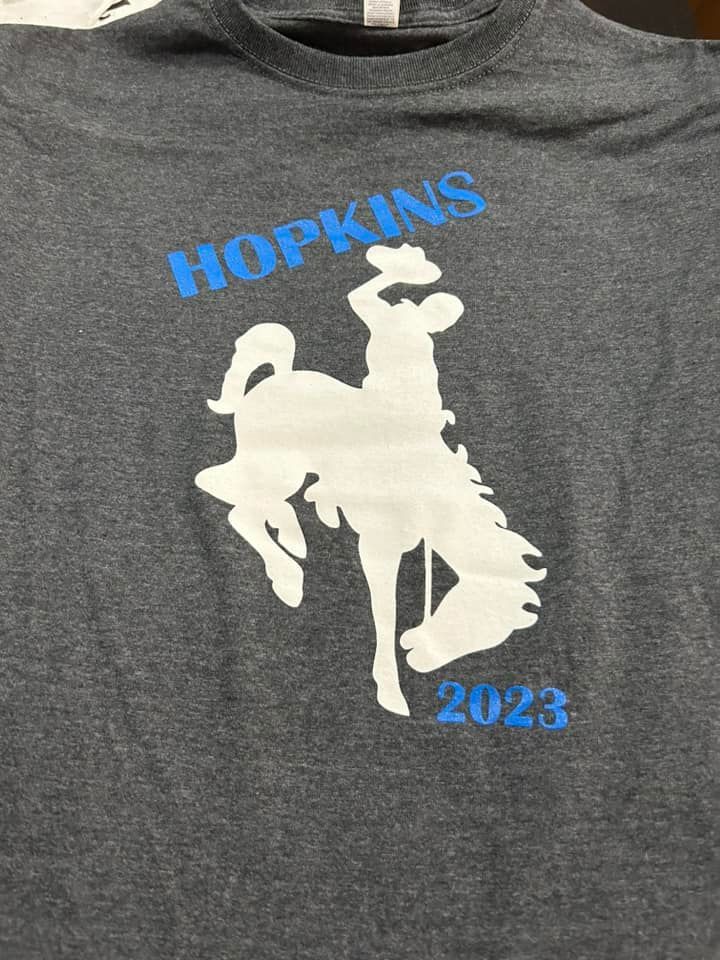 Gray T-shirt featuring a white silhouette of a bucking horse and rider, with
