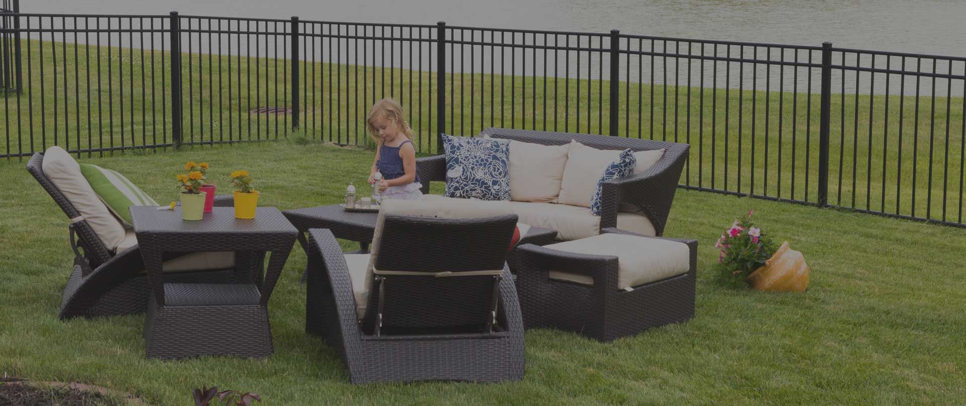 Black aluminum fence on grass