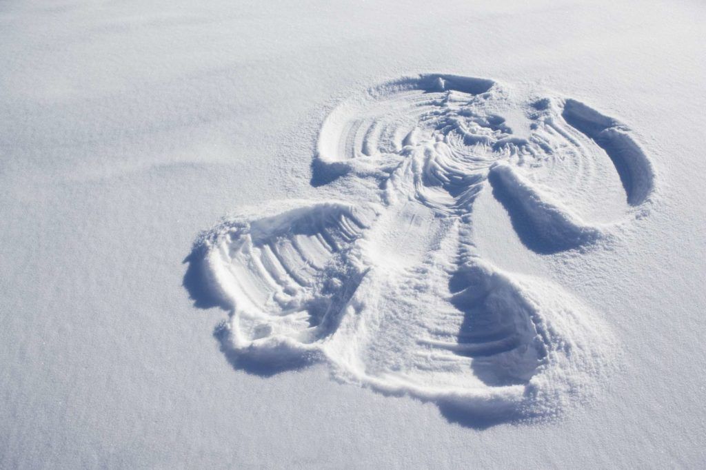 A footprint in the snow in the shape of an angel.