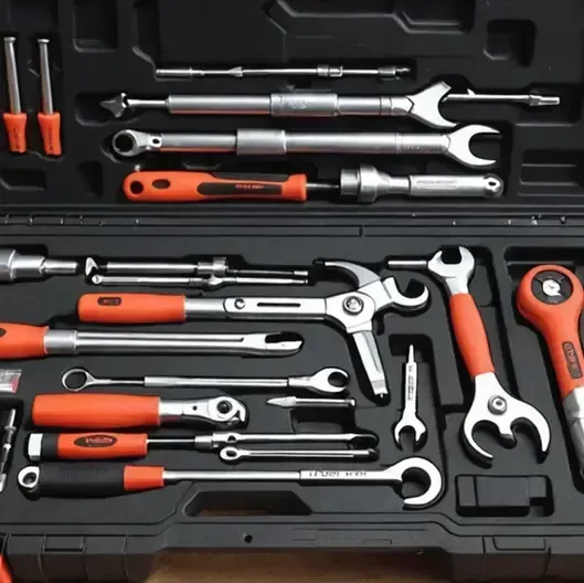 Assorted orange-handled wrenches and ratchets neatly arranged in a black tool case.