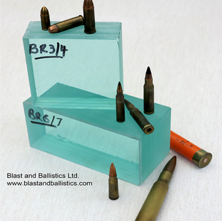 Several bullets and a shotgun shell arranged around two glass blocks labeled