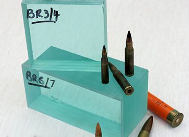 Two thick, teal-tinted glass blocks labeled