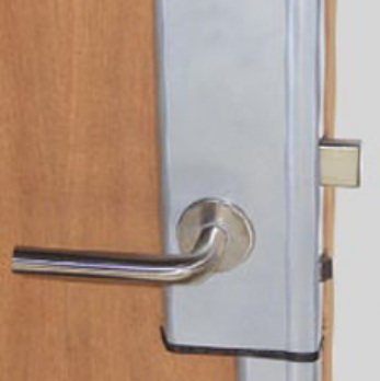 A metal lever door handle with a security plate mounted on a wood-grain door.
