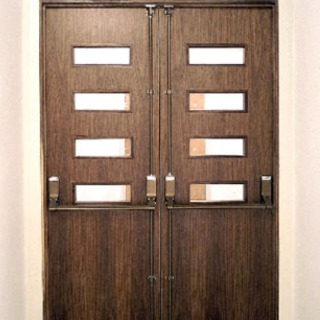 Dark wood double doors with four horizontal glass panels each and silver crash bar exit devices.