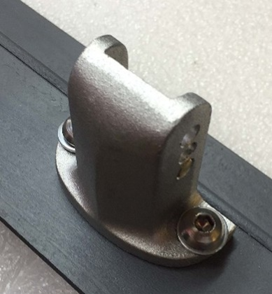 A silver metal bracket with a U-shaped top is screwed into a black frame against a white, textured background.