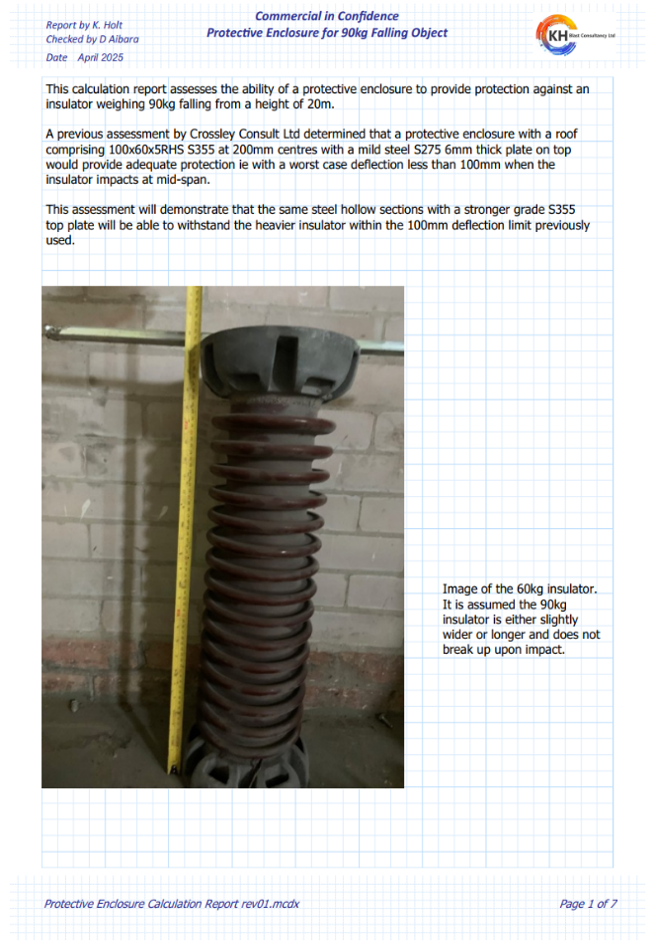 A vertical, brown electrical insulator stands on a floor next to a yellow measuring rod against a light brick wall.