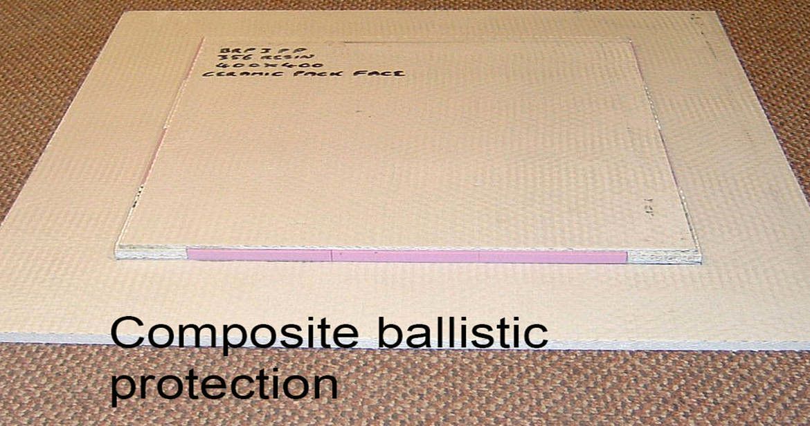 A rectangular panel of composite ballistic material with a visible pink layer, labeled 