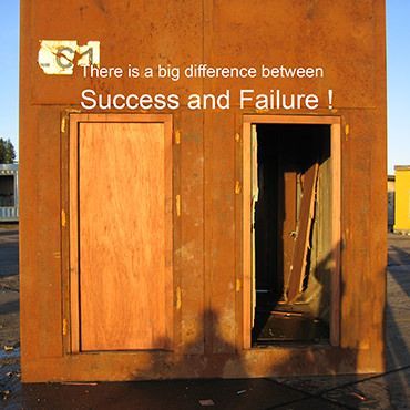 A rusted metal wall features two doorways: one is closed with a wooden panel, the other is open, with the text above it.