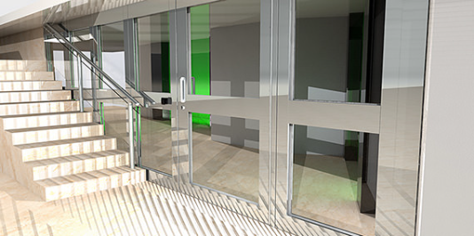 A modern staircase with a metal railing sits next to a glass door entryway with green interior walls.