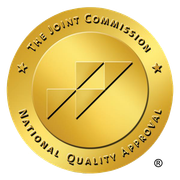 The Joint Commission National Quality Approval seal, gold with logo and text.