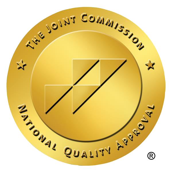 The Joint Commission seal, gold, with text 