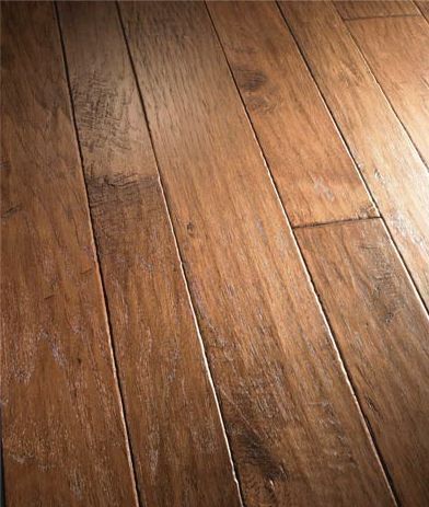 A close up of a wooden floor with a dark background