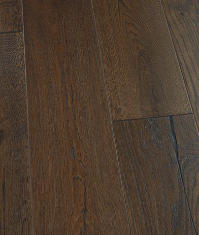 A close up of a dark brown wooden floor.