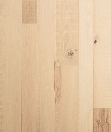 A close up of a wooden floor with a screw in it.