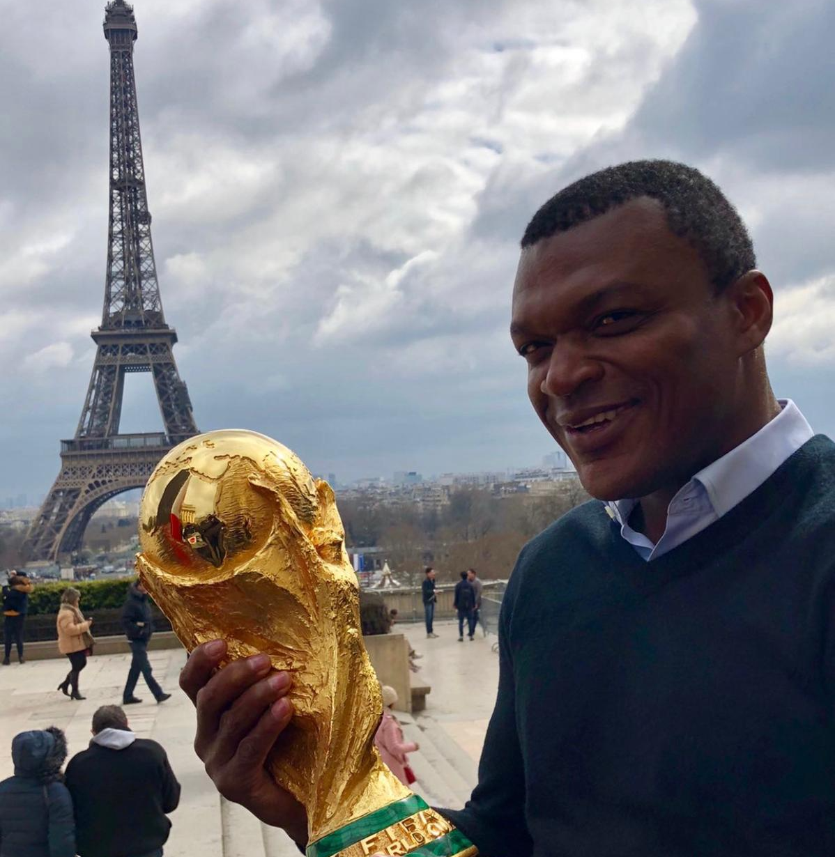marcel posing with a town in the background