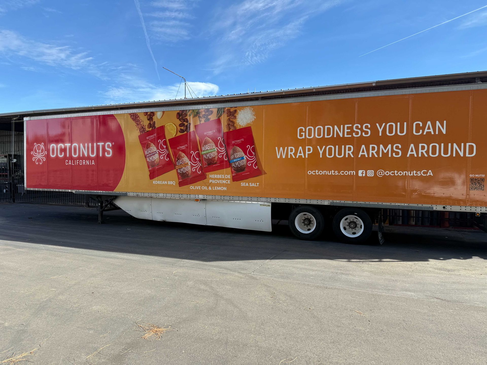 Long orange trailer with Octonuts ad and text “Goodness you can wrap your arms around”