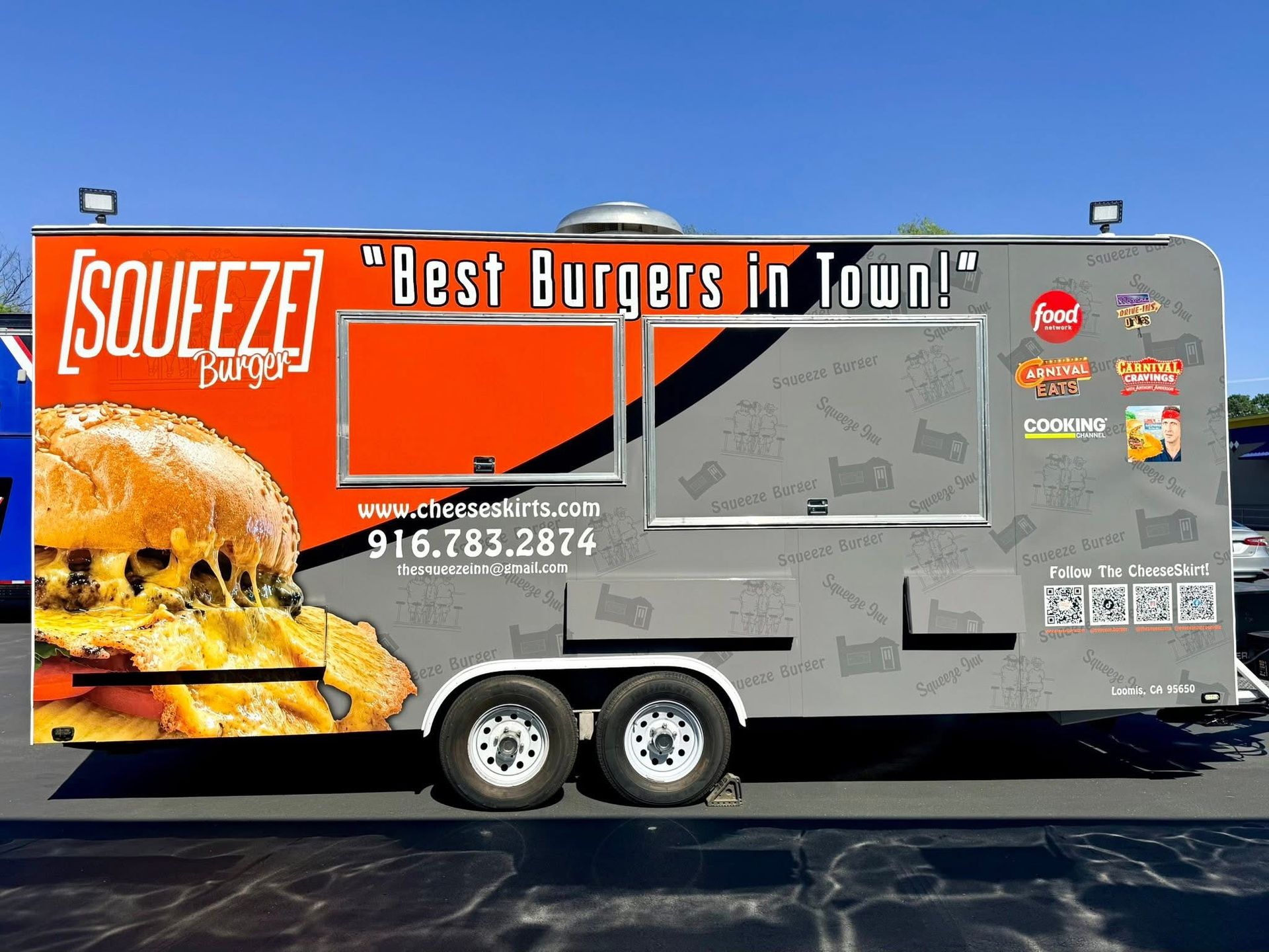 Squeeze Burgers food truck with orange-and-gray wrap and “Best Burgers in Town!” signage