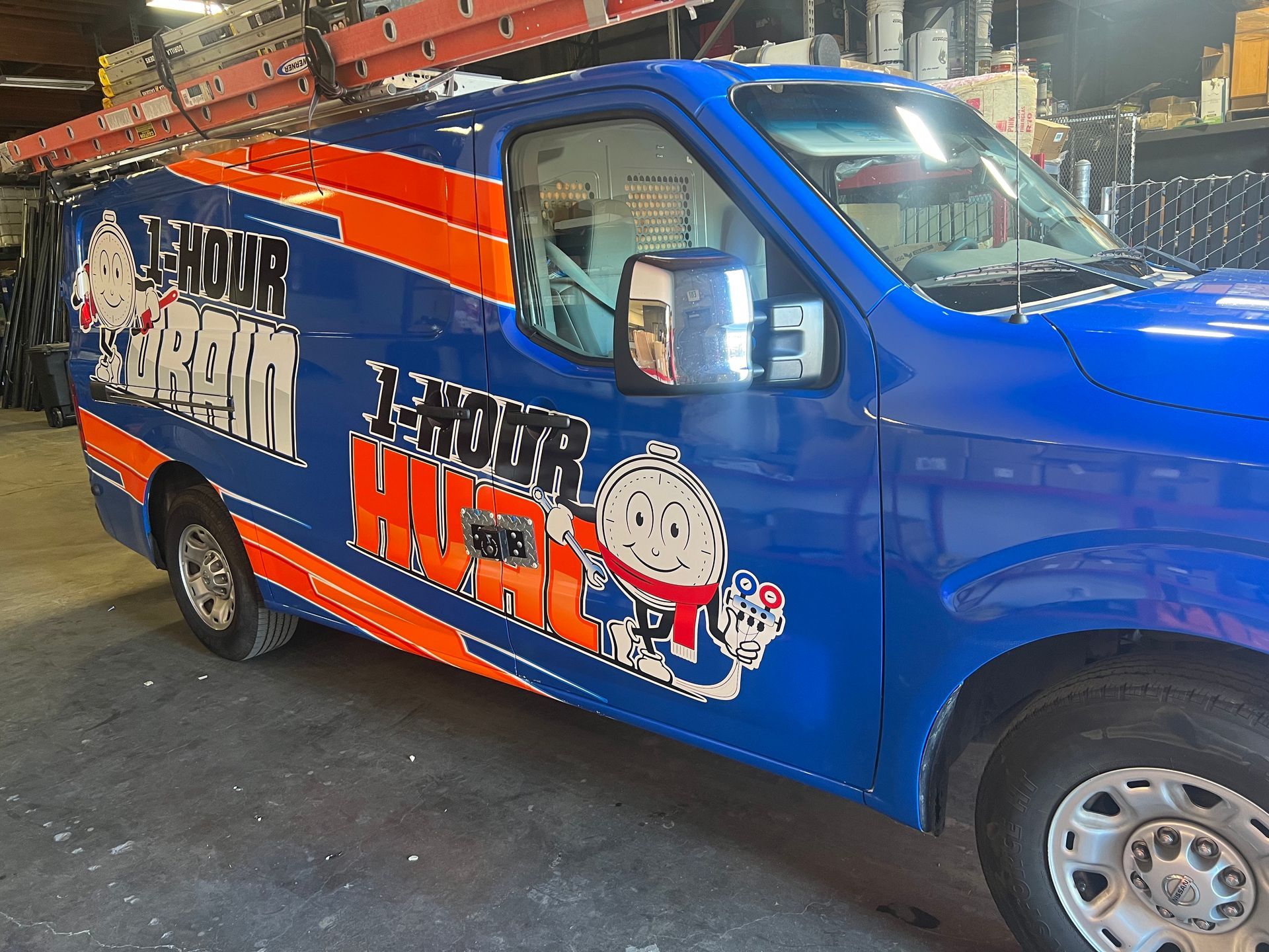 a blue and orange van is parked in a garage