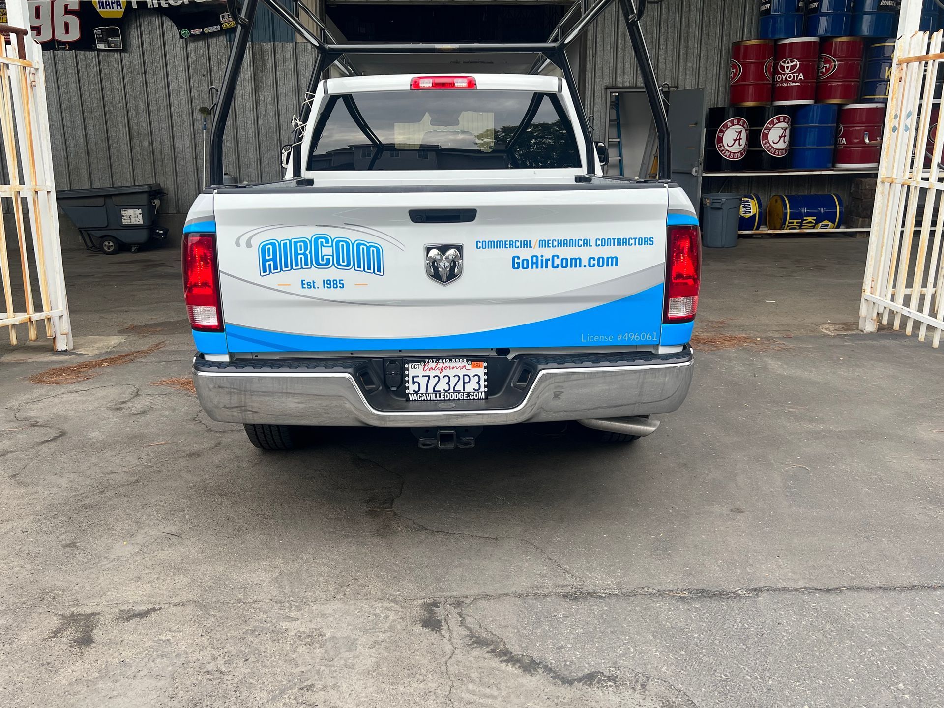 a white and blue truck is parked in front of a building .