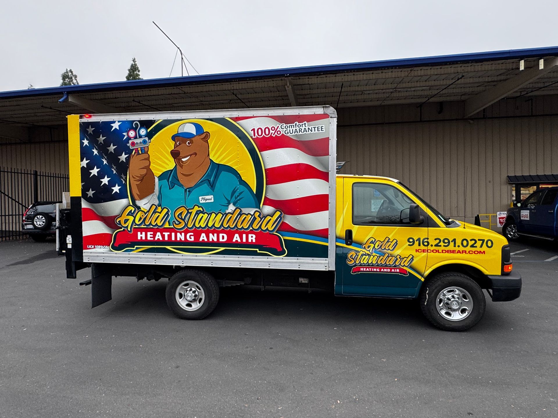 Colorful Brisket painting and air truck parked beside a warehouse