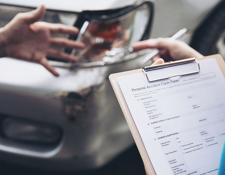 Car clipboard with a printed form beside a blurred car interior and person’s hands holding a wallet