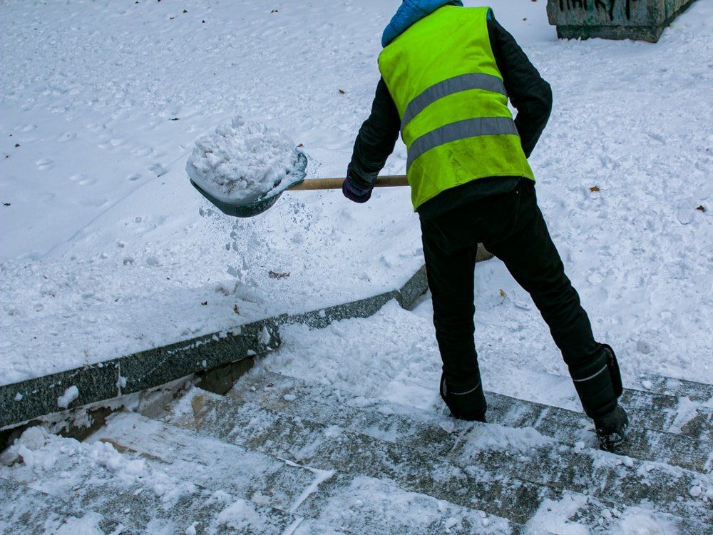 Steps being shoveled clear of snow in Carson City Snow removal by shoveling in Carson City Nevada