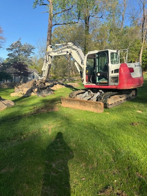 A bulldozer is cutting down trees in the woods.