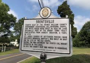 A historical marker for Brentsville, Prince William County, standing on a grassy roadside under a blue sky. A historical marker for Brentsville, Prince William County, standing on a grassy roadside under a blue sky.