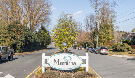 An oval community entrance sign reading 