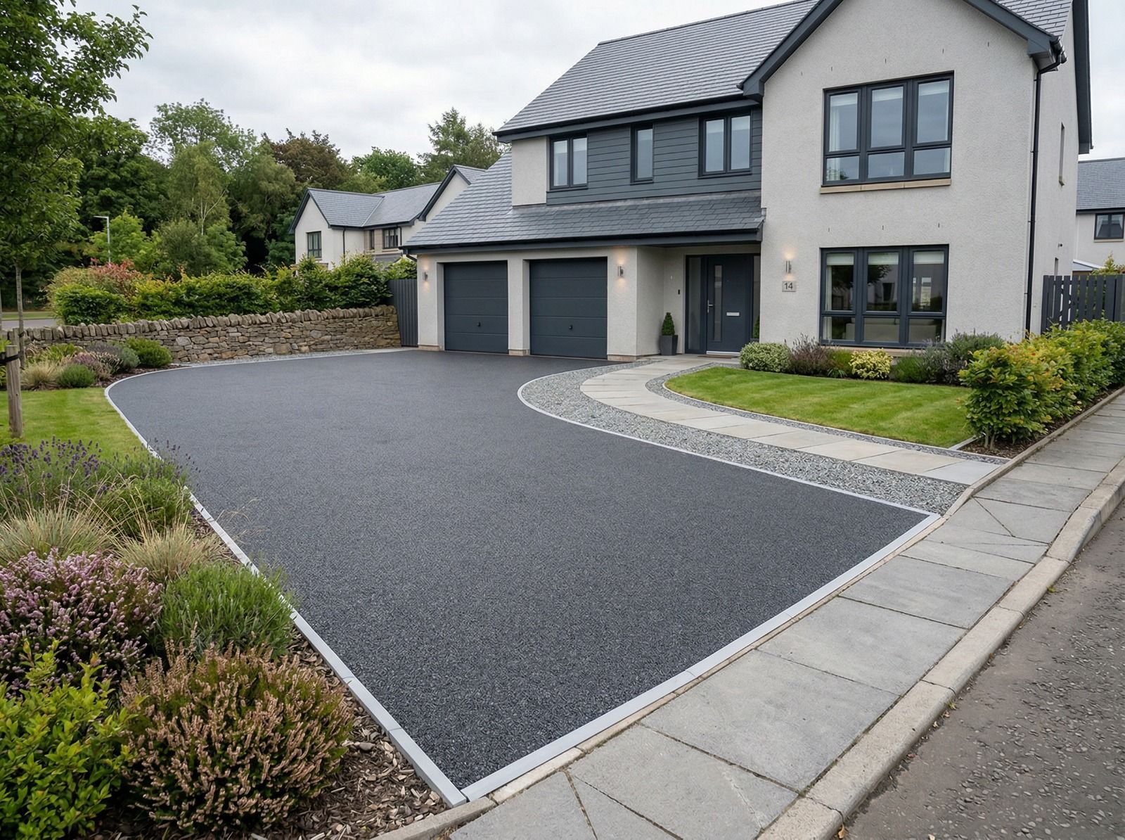 Charcoal resin-bound driveway in Glasgow with defined light grey edging and a modern premium finish