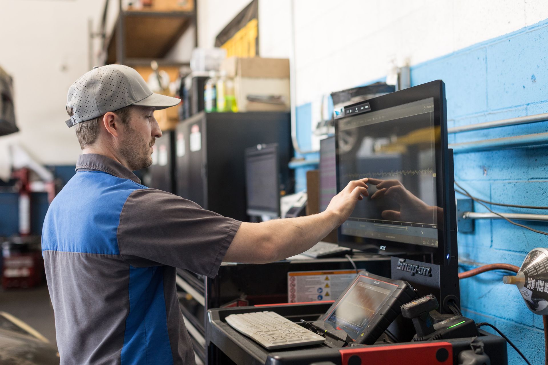Mechanic working on a computer diagnostic screen in an auto repair shop | Sean's Auto Care