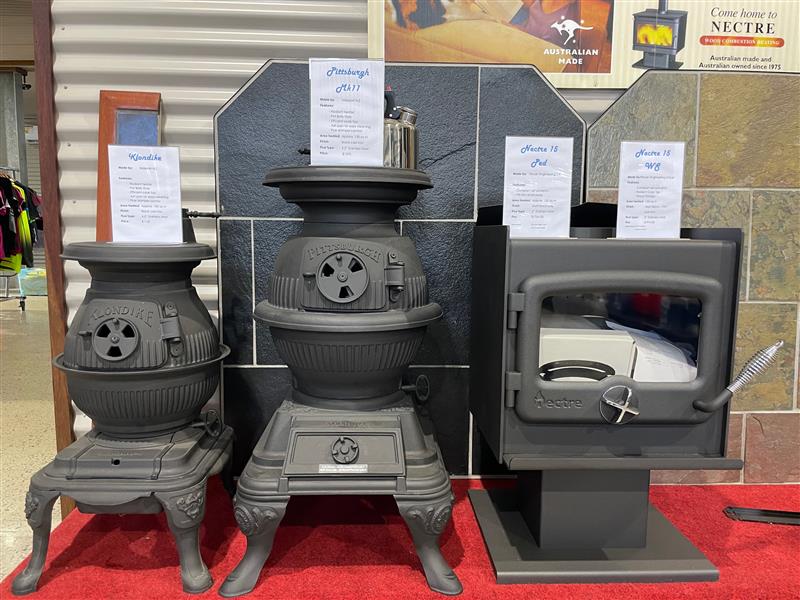 Three Wood Stoves Are Sitting on a Table in a Store — Tolga Traders in  Tolga, QLD