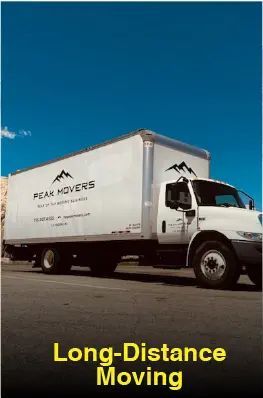 A white moving truck is parked on the side of the road.