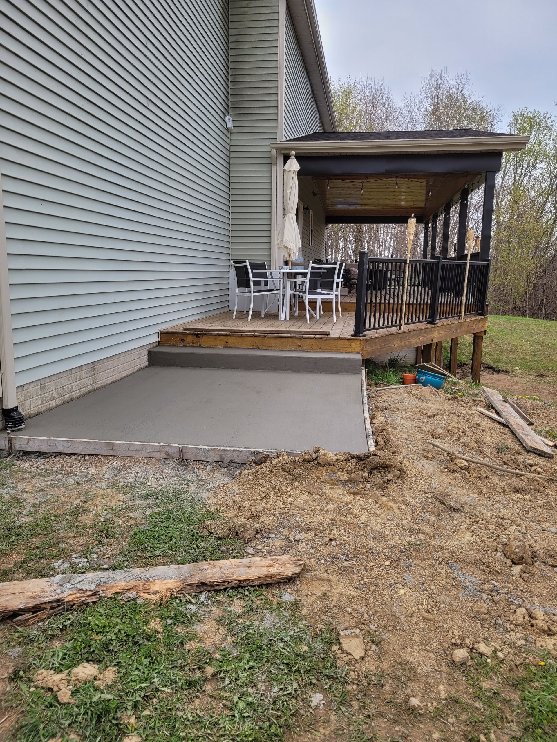 A construction worker is using a trowel to level a concrete floor.