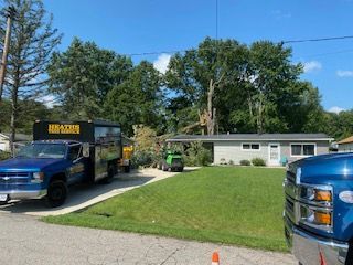 A blue truck is parked in front of a house.