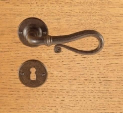 Primo piano della maniglia di una porta e della serratura su una superficie di legno.
